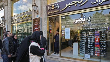 People walk past a currency exchange shop in the Iranian capital Tehran, on April 24, 2019. (AFP)