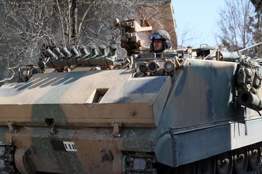 A Turkish military infantry fighting vehicle (IFV) drives through the village of Matarim in the south of Syria's northwestern province of Idlib, near the M4 motorway that connects Aleppo with Latakia, on February 17, 2020. (AFP)