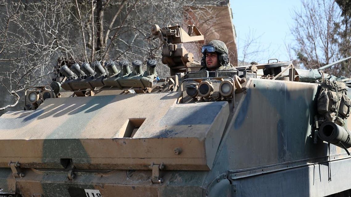 A Turkish military infantry fighting vehicle (IFV) drives through the village of Matarim in the south of Syria's northwestern province of Idlib, near the M4 motorway that connects Aleppo with Latakia, on February 17, 2020. (AFP)