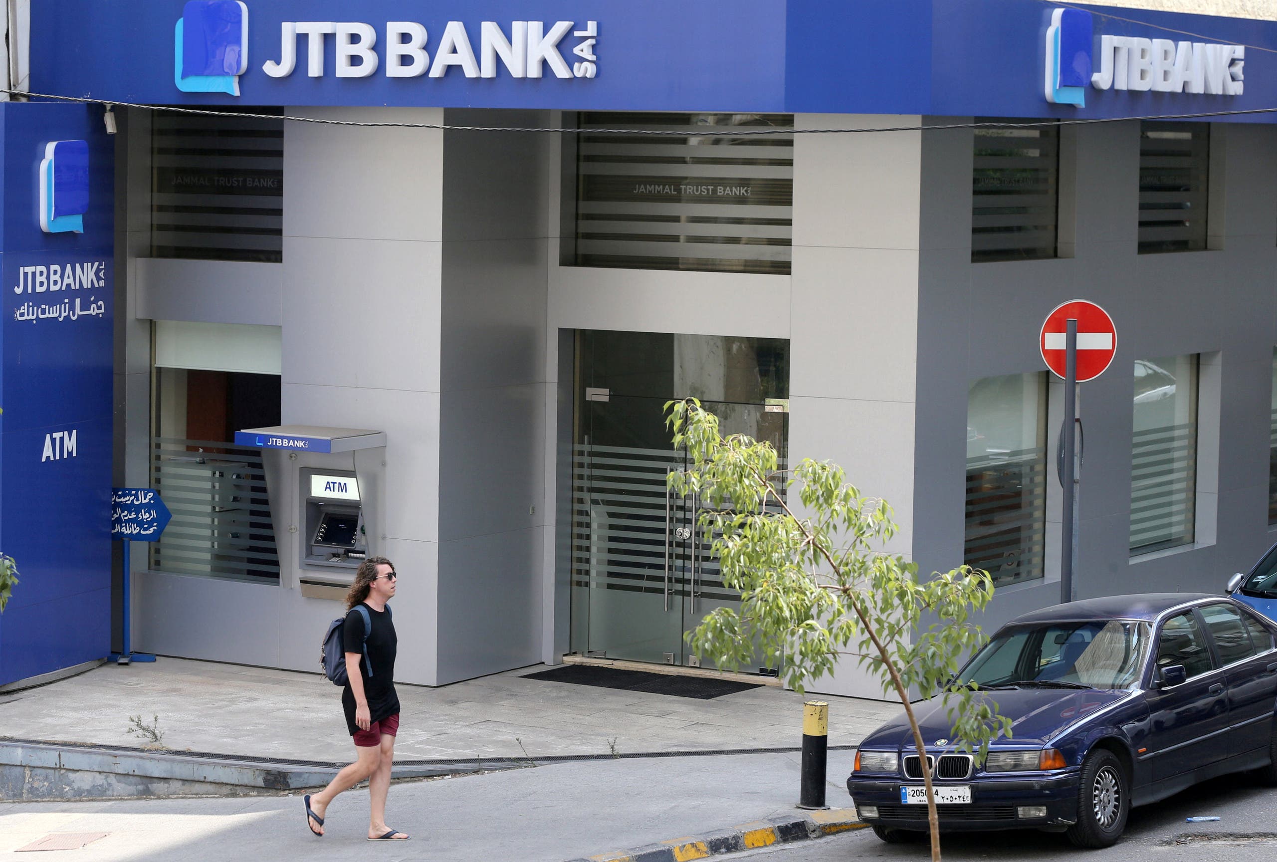 A pedestrian walks past Jammal Trust Bank (JTB) branch in Beirut, Lebanon. (Reuters)