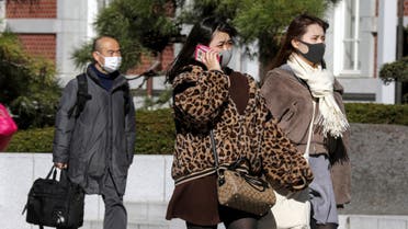 People wearing a protective face mask, following an outbreak of the coronavirus, are seen outside of Tokyo Station in Tokyo, Japan. (Reuters)