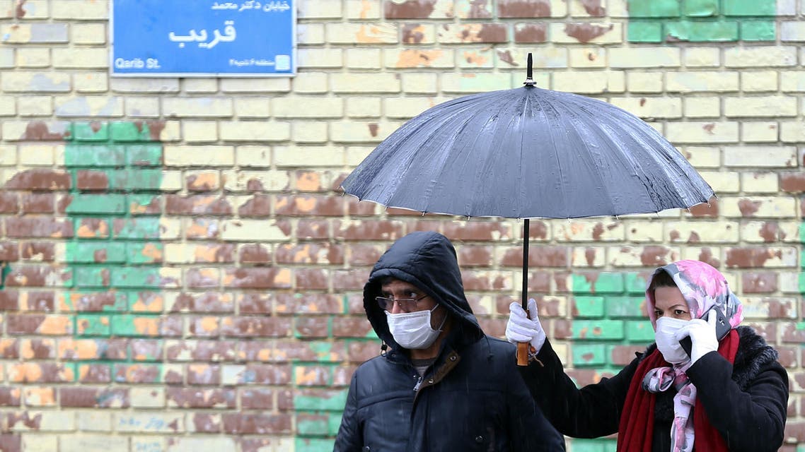Iranian people wear protective masks to prevent contracting coronavirus, as they walk in the street in Tehran, Iran, February 25, 2020. (Reuters)