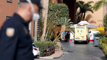 People are seen in H10 Costa Adeje Palace area, which is on lockdown after cases of coronavirus have been detected there in Adeje, on the Spanish island of Tenerife. (Reuters)