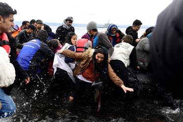 Migrants arrive with a dinghy at the village of Skala Sikaminias, on the Greek island of Lesbos, after crossing the Aegean sea from Turkey, on Friday, Feb. 28, 2020. (AP)
