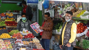 Vendors wear protective face masks following the coronavirus outbreak, as they work at a local vegetables and fruits market in Sanabis west of Manama. (Reuters)