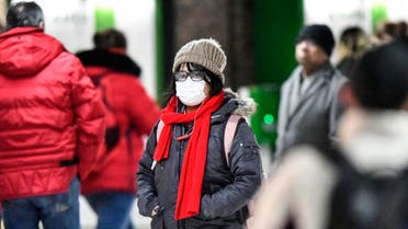 A woman wears a face mask at the main train station in Duesseldorf, Germany, Wednesday, Feb. 26, 2020. (AP)