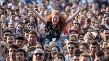 A festival goer waves during the concert of Icelandic blues/rock band Kaleo atthe 43rd Paleo music festival on July 17, 2018 in Nyon, western Switzerland. (AFP)