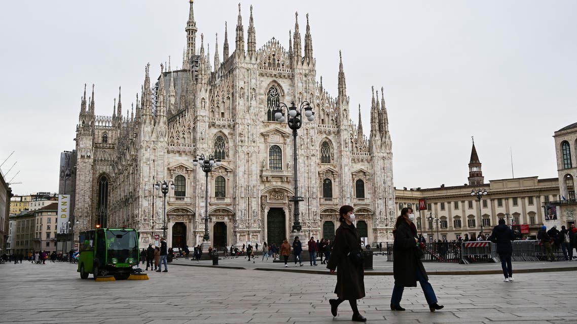 A photo shows people walking on an almost empty Piazza del Duomo in central Milan, on February 27, 2020 amid fears over the spread of the novel Coronavirus. (AFP)