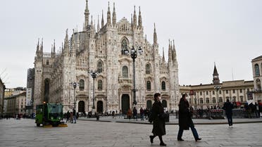A photo shows people walking on an almost empty Piazza del Duomo in central Milan, on February 27, 2020 amid fears over the spread of the novel Coronavirus. (AFP)