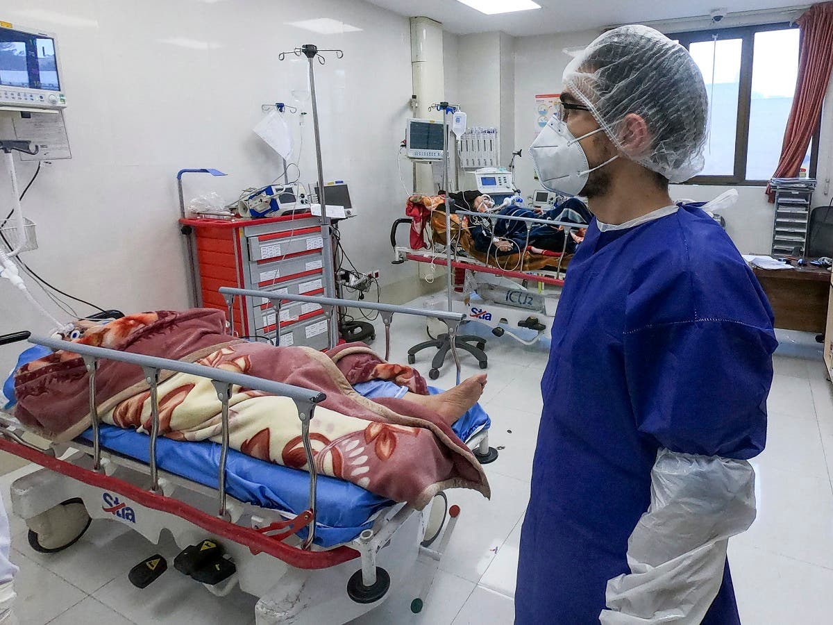 A nurse cares for patients in a ward dedicated for people infected with the coronavirus, at Forqani Hospital in Qom, 78 miles (125 kilometers) south of the capital Tehran, Iran. (AP)