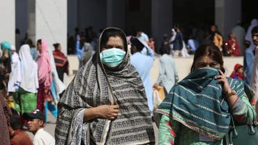 Pakistani women wearing face masks leave the Aga Khan hospital where a patient suspected of having contracted coronavirus was admitted, in Karachi. (AP)
