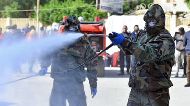 Members of the Iraqi civil defense spray disinfectant on and around a building where Islamic students are quarantined for having had contact with Iraq's first confirmed case of novel coronavirus infection, in the central holy city of Najaf, on February 26, 2020. Najaf's authorities have beefed up precautionary measures since Iraq's first case of COVID-19 infection was confirmed on February 24, in an Iranian national studying in a Shiite seminary in the holy city.