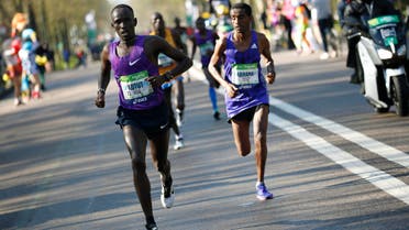 File photo of the Kenyan Cyprian Kotut (left) runs during the 40th Paris Marathon, on April 3, 2016 in Paris. (AFP)