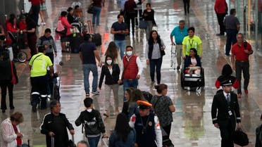 A couple wears protective masks as a precaution against the spread of the new coronavirus at the airport in Mexico City, Friday, February 28, 2020. (AP)