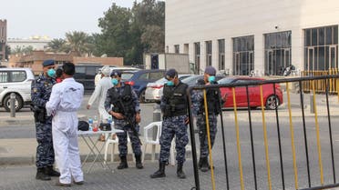 Members of Kuwait's national guard wearing safety masks keep watch outside a hotel in the capital where Kuwaitis returning from Iran are quarantined and tested for coronavirus COVID-19, on February 24, 2020. (AFP)
