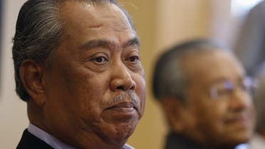 UMNO's Deputy President Muhyiddin Yassin (L) and former prime minister Mahathir Mohamad give a news conference in Putrajaya, Malaysia. (Reuters)