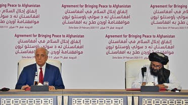 S Special Representative for Afghanistan Reconciliation Zalmay Khalilzad and Taliban co-founder Mullah Abdul Ghani Baradar sign a peace agreement during a ceremony in the Qatari capital Doha on February 29, 2020. (AFP)