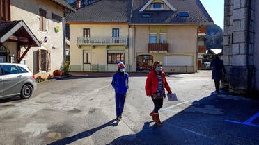 People wear protective face masks as a safety measure against COVID-19, the novel coronavirus, on February 28, 2020, in La Balme-de-Sillingy, central-eastern France, where two new coronarivus cases where detected, adding to the four already found the town. (AFP)