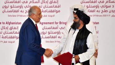 (L to R) US Special Representative for Afghanistan Reconciliation Zalmay Khalilzad and Taliban co-founder Mullah Abdul Ghani Baradar sign a peace agreement during a ceremony in the Qatari capital Doha on February 29, 2020 The United States signed a landmark deal with the Taliban, laying out a timetable for a full troop withdrawal from Afghanistan within 14 months as it seeks an exit from its longest-ever war.
