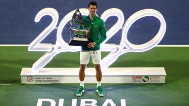 Serbia's Novak Djokovic poses with the trophy after winning the final against Greece’s Stefanos Tsitsipas at the Dubai Duty Free Tennis Stadium on February 29, 2020. (Reuters)