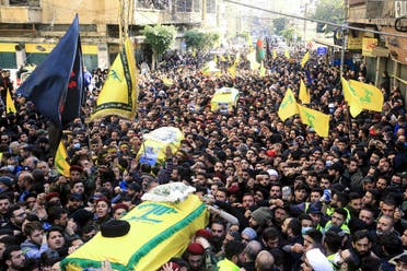 Supporters of Lebanon’s Hezbollah carry the coffins during a funeral procession in a suburb of the Lebanese capital Beirut, on March 1, 2020. (AFP)