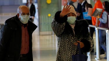 Tourists from Morocco wear masks to prevent contracting coronavirus at the Malaga-Costa del Sol airport, in Malaga, southern Spain, January 29, 2020. (Reuters)