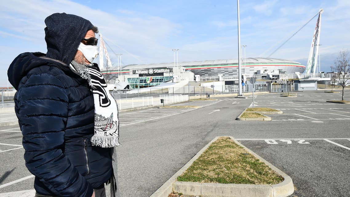 A man wearing a face mask is seen outside the Allianz Stadium, after five Serie A matches were postponed because of the ongoing coronavirus crisis, in Turin, Italy, February 29, 2020. (Reuters)