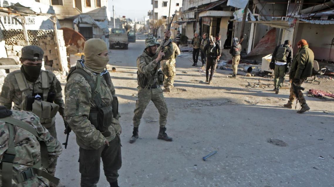 Turkey-backed Syrian fighters celebrate in the town of Saraqib in the eastern part of the Idlib province in northwestern Syria, on February 27, 2020. (AFP)