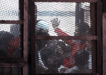 The accused are seen in a metal cage during a trial of 200 people charged with belonging to the Ansar Bait al-Maqdis group, in a court in Cairo March 5, 2015. (Reuters)