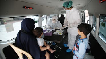 Doctors check a traveller in their designated residential area to check on residents who returned from Iran if anyone is infected with the coronavirus, at Isa Town Health Center, south of Manama, Bahrain, March 2, 2020. (Reuters)