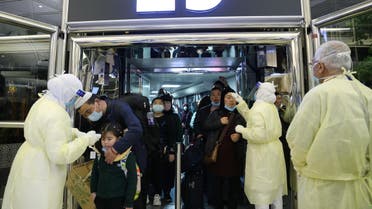 Passengers coming from China wearing masks to prevent a new coronavirus are checked by Saudi Health Ministry employees upon their arrival at King Khalid International Airport, in Riyadh, Saudi Arabia. (File photo: Reuters)
