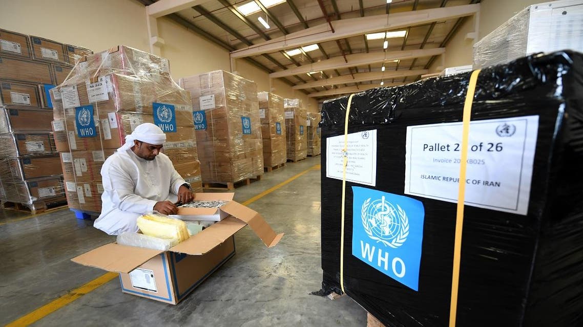 Officials check medical equipment and coronavirus testing kits provided by WHO at the al-Maktum International airport in Dubai on March 2, 2020. (AFP)