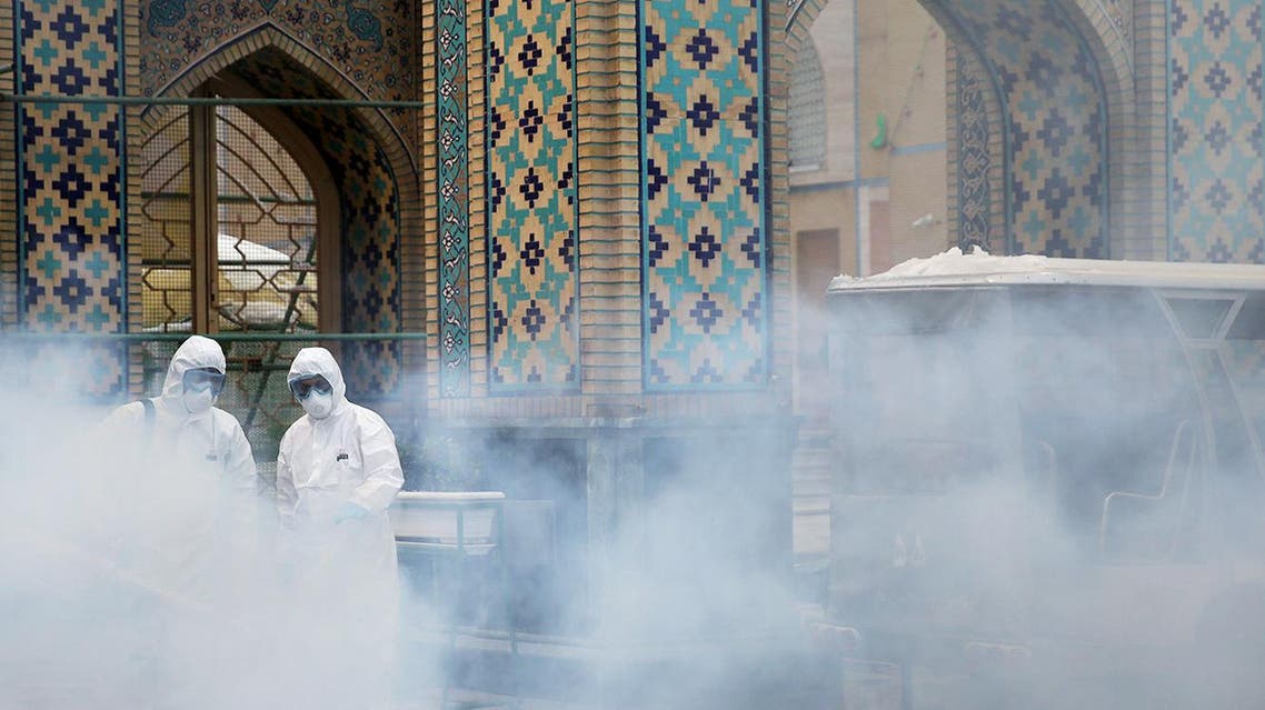 Members of the medical team spray disinfectant to sanitize outdoor place of Imam Reza's holy shrine, following the coronavirus outbreak, in Mashhad, Iran