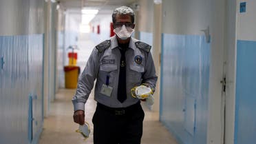 A security officer carries masks as he walks at a new section specialized in receiving any person who may have been infected with coronavirus, at the Al-Bashir Governmental Hospital in Amman, Jordan January 28, 2020. (Reuters)