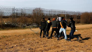 Migrants try to bring down part of a border fence on the Turkish-Greek border at Turkey's Pazarkule border crossing with Greece's Kastanies, near Edirne. (Reuters)