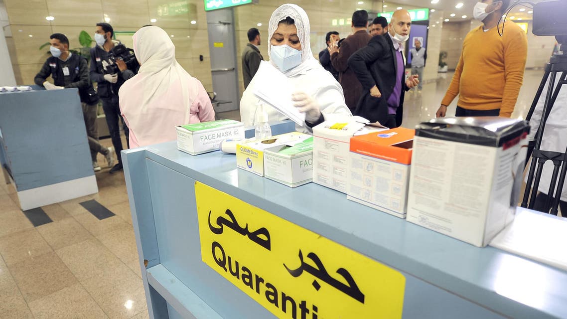 Egyptian Quarantine Authority employees prepare to scan body temperature for incoming travelers at Cairo International Airport to detect coronavirus. (File photo: AFP)