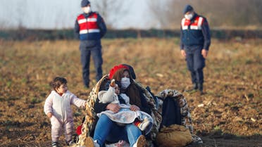 Migrants rest next to the Turkey's Pazarkule border crossing with Greece's Kastanies, near Edirne, Turkey, March 3, 2020. REUTERS/Leonhard Foeger
