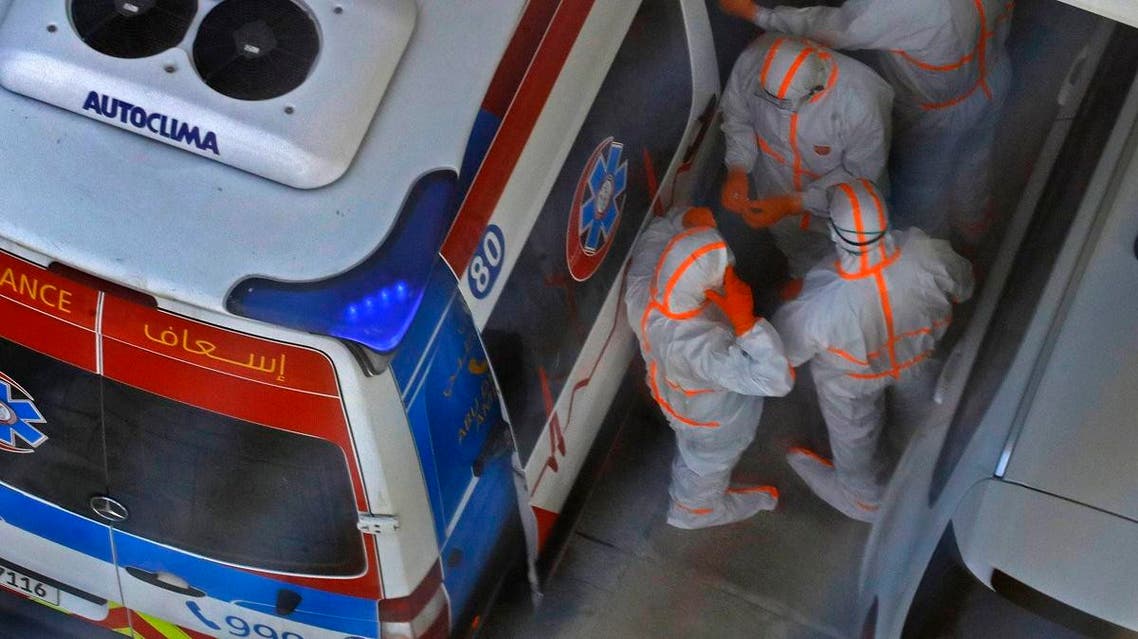 This picture picture taken on February 28, 2020 shows an ambulance and an emergency medical response team on the scene at the Crowne Plaza hotel at Yas Island Abu Dhabi, United Arab Emirates. (AFP)