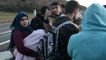 This picture taken from the Greek side of the Greece-Turkey border near Kastanies, shows migrants arrested by police, on March 3, 2020. Greece was on a state of alert on March 1, 2020 as it faced an influx of thousands of migrants seeking to cross the border from Turkey, with locals fearing a new immigration crisis. More than 13,000 migrants have gathered on the Turkish side of the river which runs 200 kilometres (125 miles) along the frontier and separates them from Greece and therefore the European Union. The flow of migrants from Turkey has triggered EU fears of a re-run of the 2015 migrant emergency when Greece became the main EU entry point for a million migrants, most of them refugees fleeing the Syrian civil war.