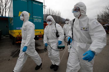 South Korean soldiers wearing protective gears walk to spray disinfectant as a precaution against the coronavirus in Seoul, South Korea on March 3, 2020. (AP)