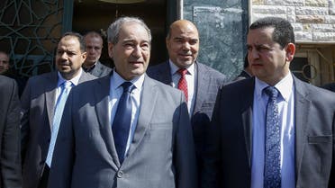 Syrian Deputy Foreign Minister Faisal Miqdad (front L) and Libya's parallel eastern government foreign minister Abdulhadi Lahweej (front R) and deputy Prime Minister Abdul Rahman Al-Ahiresh (back R), leave the Libyan Embassy in Damascus after reopening it on March 3, 2020. (AFP)