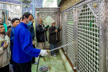 A a man disinfects the shrine of Saint Masoumeh against coronavirus in the city of Qom, Iran. (AP)