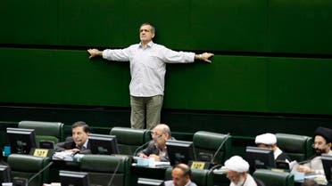 Iranian lawmaker, Masoud Pezeshkian, stretches his arms as he attends in an open session of parliament in 2009. (File photo: AP)