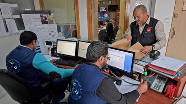  Members of the Tunisian health ministry’s COVID-19 coronavirus diease crisis cell respond to phone calls at their premises at the ministry headquarters in the capital Tunis on March 3, 2020. (AFP)