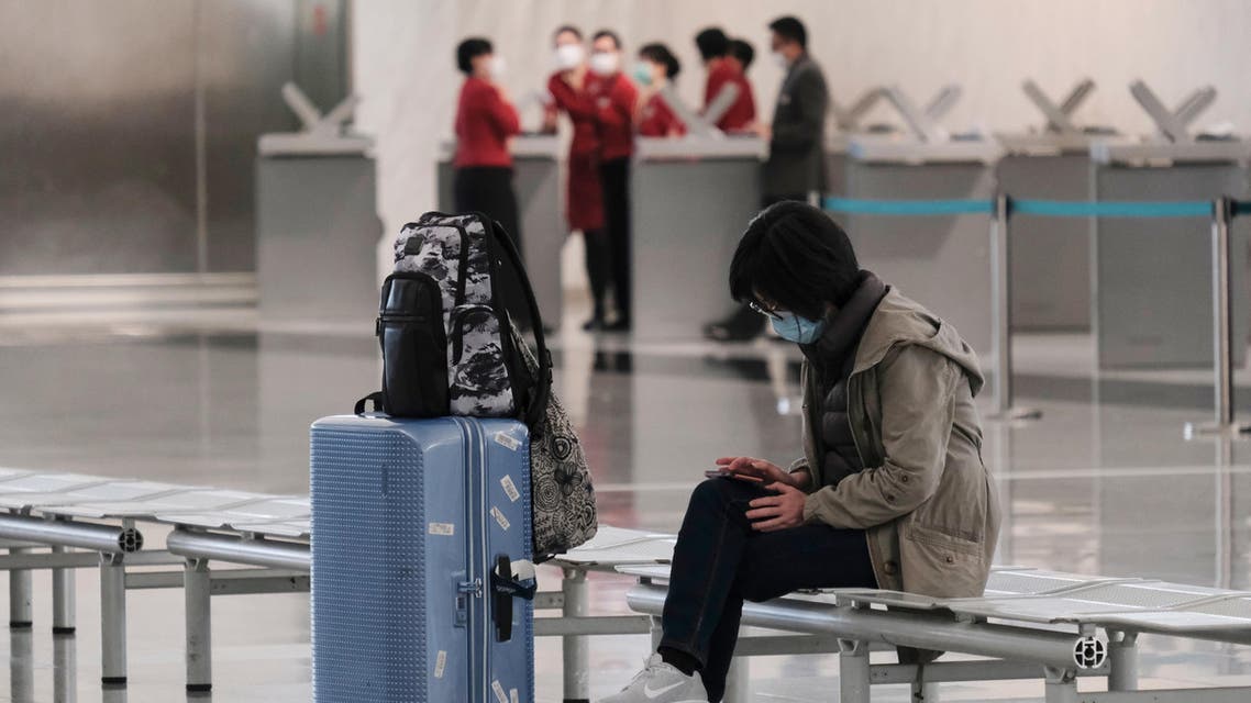A passenger wears a protective face mask at the airport, following the outbreak of the new coronavirus, in Hong Kong, China, March 5, 2020. (Reuters)