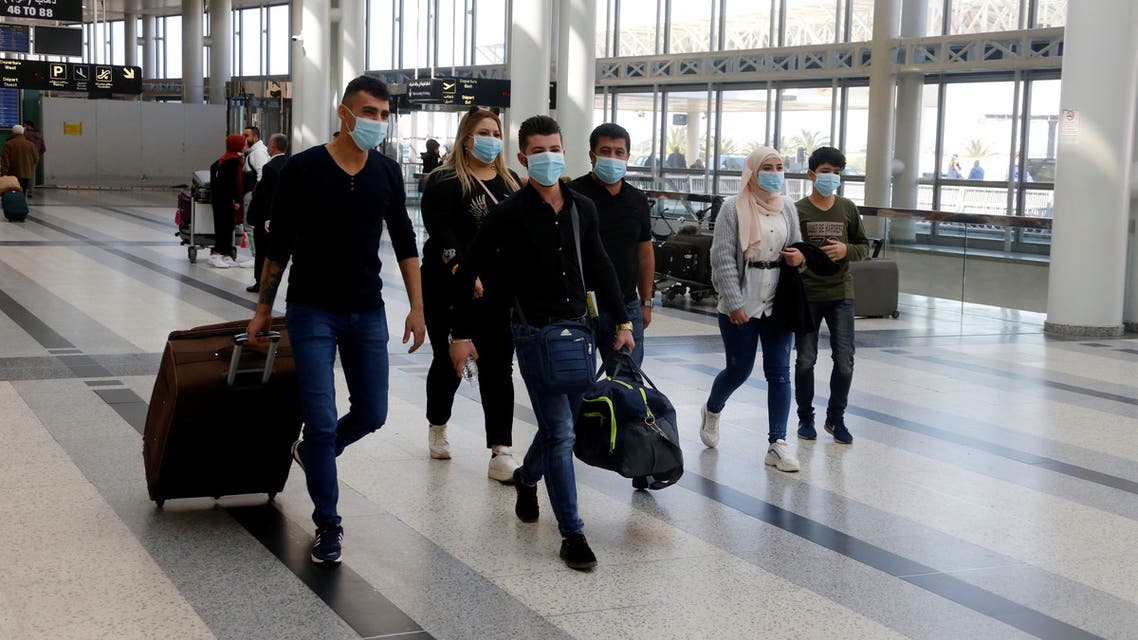 People wear facemasks as a precaution against the spread of the coronavirus, at Beirut international airport, Lebanon March 4, 2020. Picture taken March 4, 2020. REUTERS/Mohamed Azakir