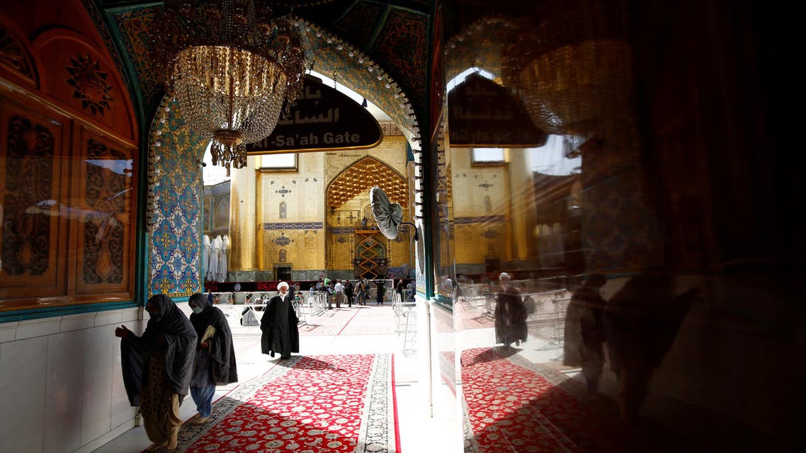Female pilgrims wearing protective face masks walk at Imam Ali Shrine, following the outbreak of coronavirus, in the holy city of Najaf, Iraq, February 27, 2020. (Reuters)
