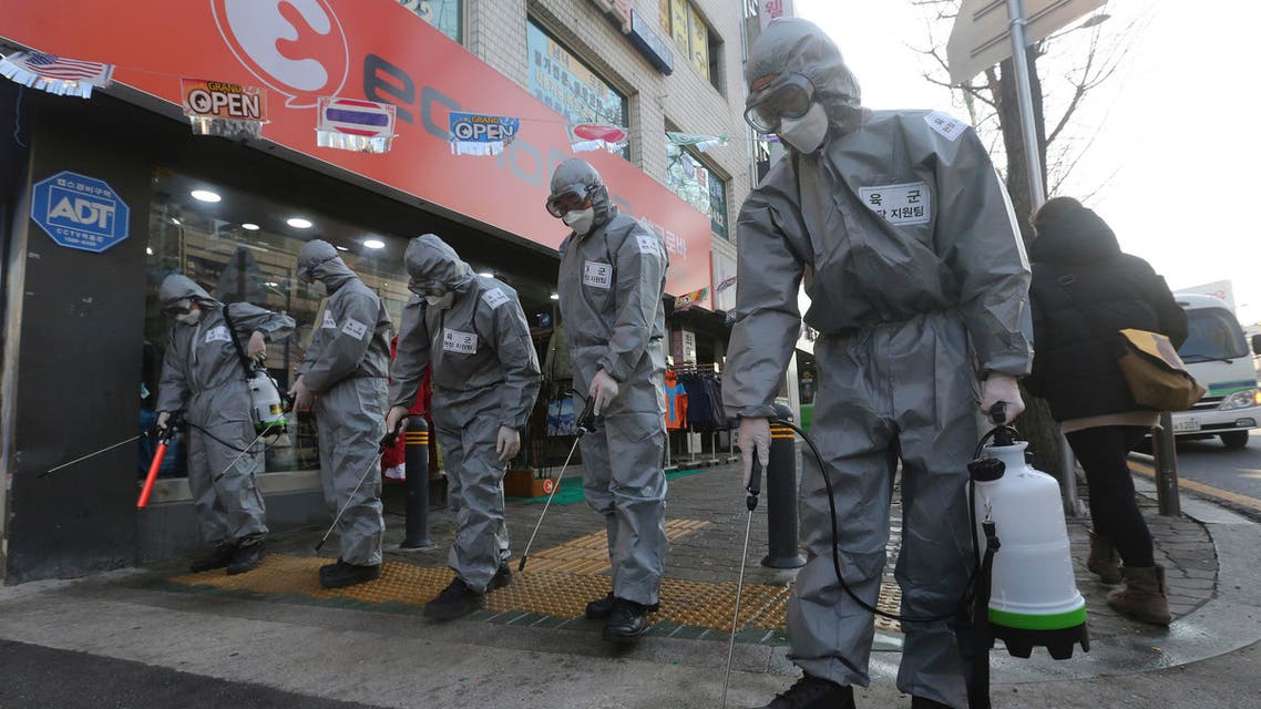 South Korean army soldiers spray disinfectant as a precaution against the new coronavirus on a street in Seoul on March 6, 2020. (AP)