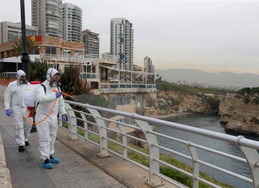 Employees from a disinfection company sanitize handrails, as a precaution against the spread of the coronavirus, at Beirut's seaside Corniche, on March 5, 2020. (Reuters) 