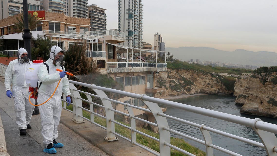 Employees from a disinfection company sanitize handrails, as a precaution against the spread of the coronavirus, at Beirut's seaside Corniche, Lebanon March 5, 2020. REUTERS/Mohamed Azakir